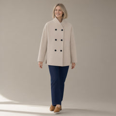 Woman wearing the cropped double-breasted coat, stand collar, full length, studio