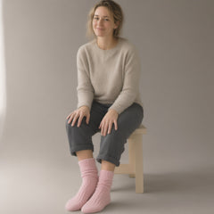 Woman wearing the fluffy bed socks — 2 pairs, full length, studio