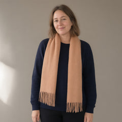 Woman wearing the wool scarf with fringe, 32 x 180 cm, full length, studio