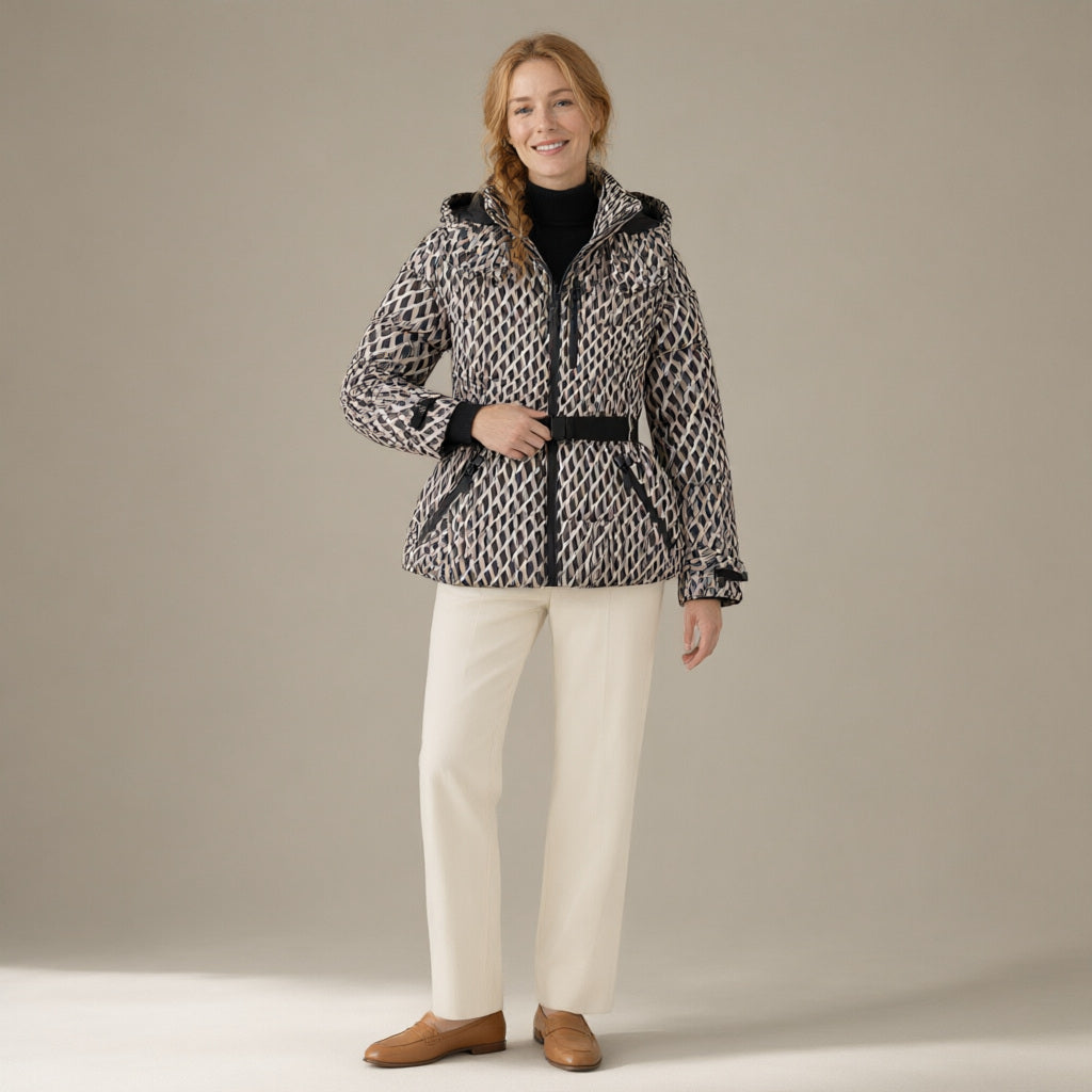 Woman wearing the belted hooded ski jacket, padded zip-front, full length, studio