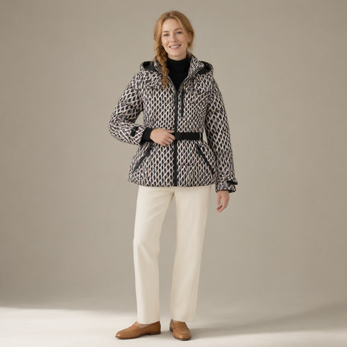 Woman wearing the belted hooded ski jacket, padded zip-front, full length, studio