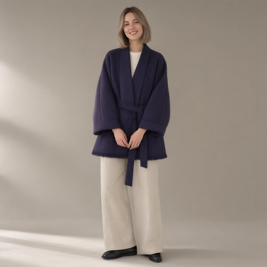 Woman wearing the belted wrap wool coat, fringed hem, full length, studio