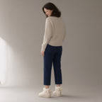 Woman wearing the bow plush ankle boots, platform sole, three-quarter view, studio