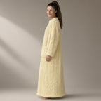 Woman wearing the cable-texture fleece nightdress, pull-on, full length, three-quarter view, studio