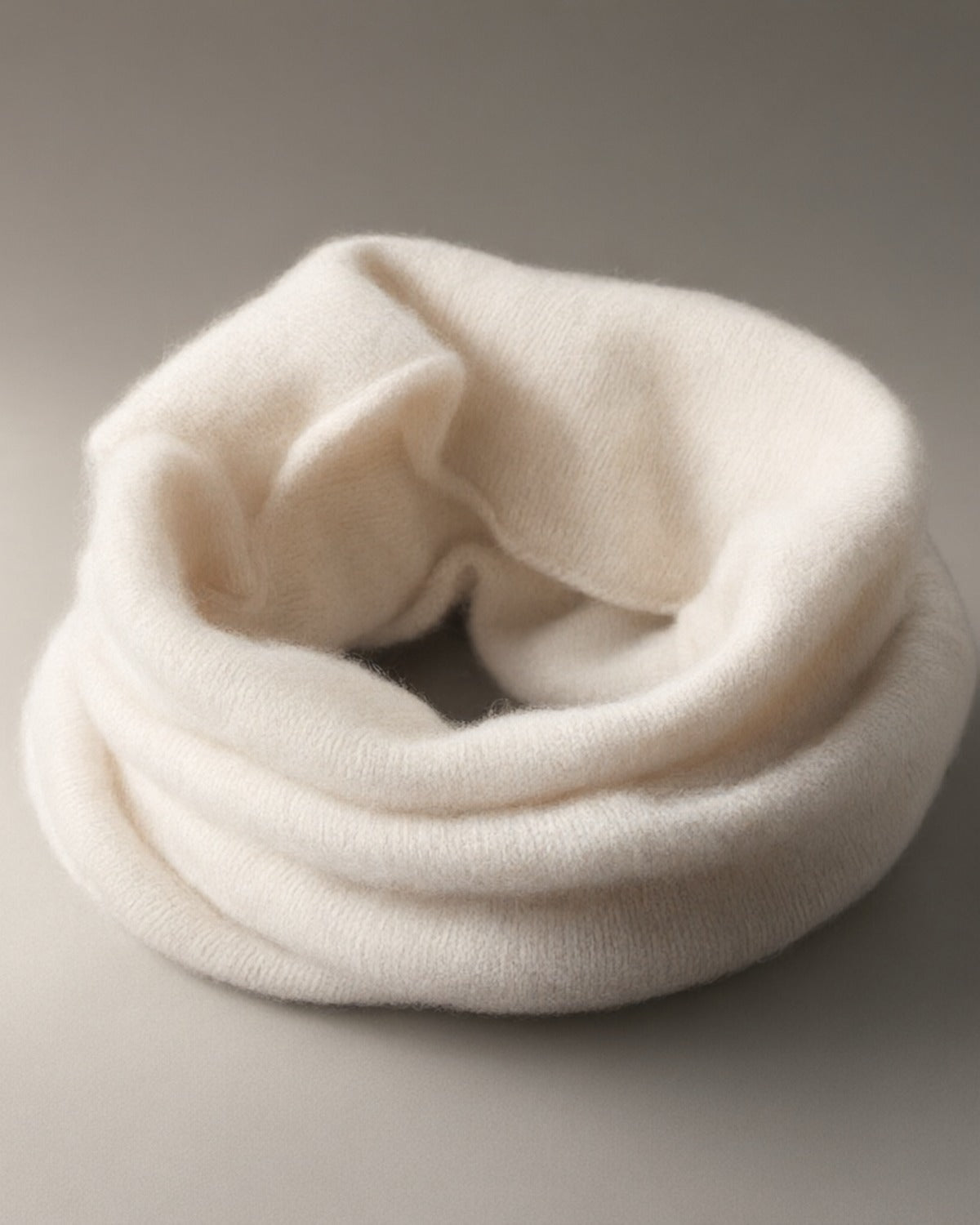 Women’s Chunky Wool Snood, Pull-On Neck Warmer, laid flat on a stone backdrop