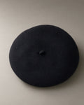 Women’s Classic Wool Beret, Knitted, laid flat on a stone backdrop