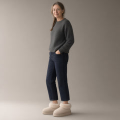Woman wearing the closed-back fleece-lined slipper boots, full length, studio