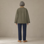 Woman seen from behind wearing the corduroy-collar barn jacket, patch pockets, back view