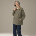 Woman wearing the corduroy-collar barn jacket, patch pockets, three-quarter view, studio