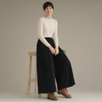 Woman wearing the wide-leg corduroy culottes, elastic waist, three-quarter view, studio