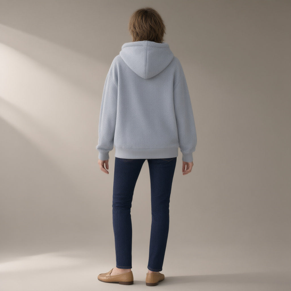 Woman seen from behind wearing the fleece hoodie, cross-front pocket, back view