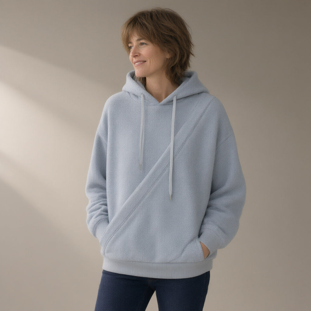 Woman wearing the fleece hoodie, cross-front pocket, three-quarter view, studio