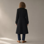 Woman seen from behind wearing the long double-breasted coat, tailored collar – black, back view