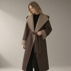 Woman wearing the double-faced wool wrap coat, hooded tie-belt, three-quarter view, studio