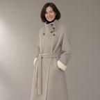 Woman wearing the belted double-faced swing coat, funnel collar, three-quarter view, studio