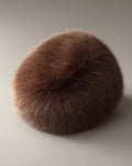 Women’s Faux Fur Cossack Hat, laid flat on a stone backdrop