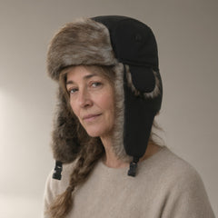 Woman wearing the faux fur trapper hat, fold-down ear flaps, full length, studio