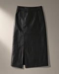 Women’s Faux Leather Midi Skirt, Front Split, laid flat on a stone backdrop