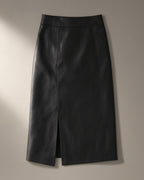 Women’s Faux Leather Midi Skirt, Front Split, laid flat on a stone backdrop