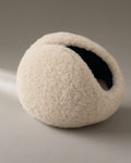 Women’s Windproof Fleece Earmuffs, Folding Band, laid flat on a stone backdrop