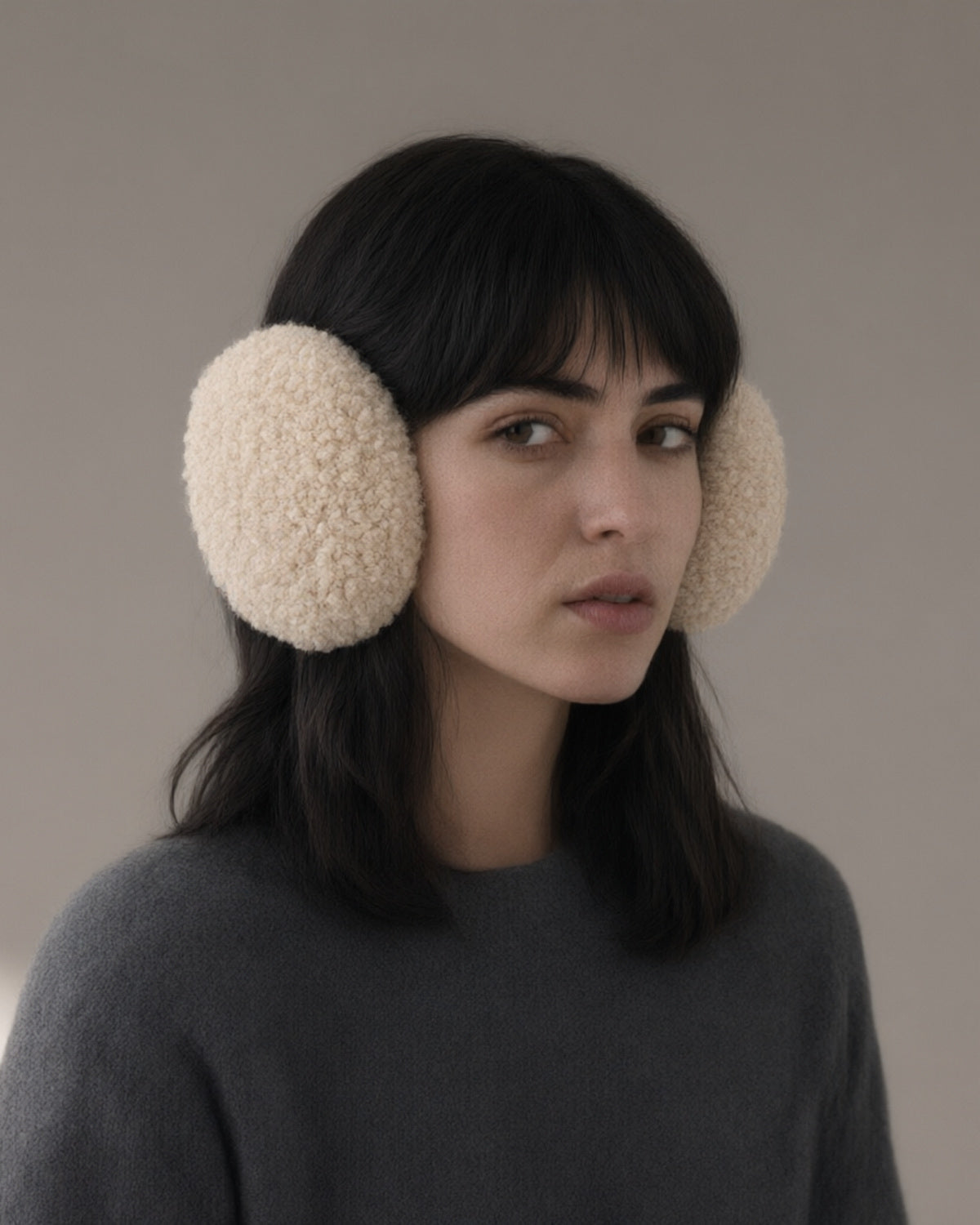 Woman wearing the windproof fleece earmuffs, folding band, full length, studio
