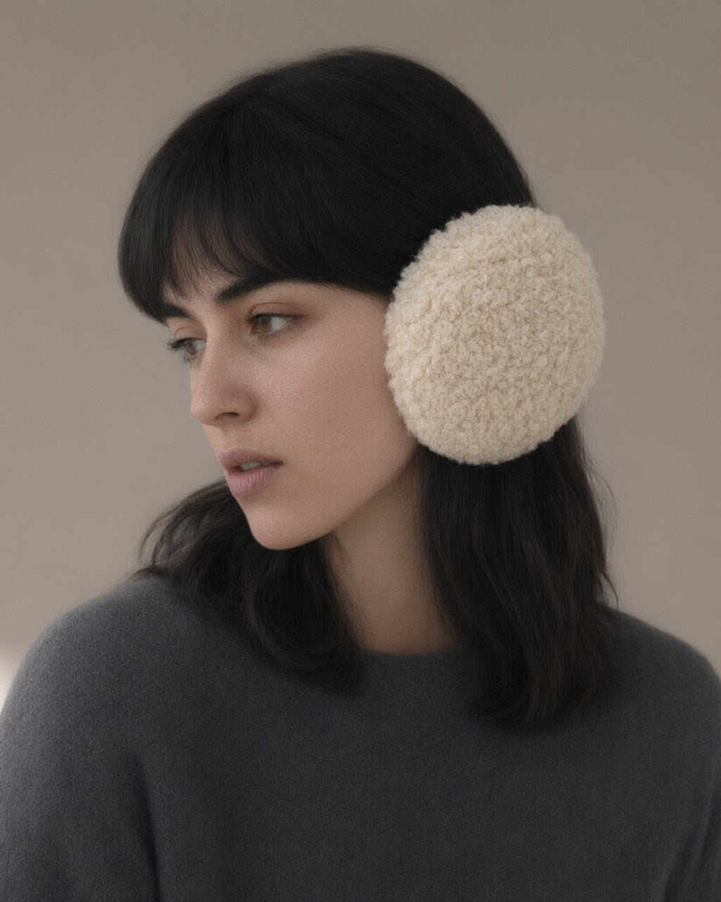Woman wearing the windproof fleece earmuffs, folding band, three-quarter view, studio