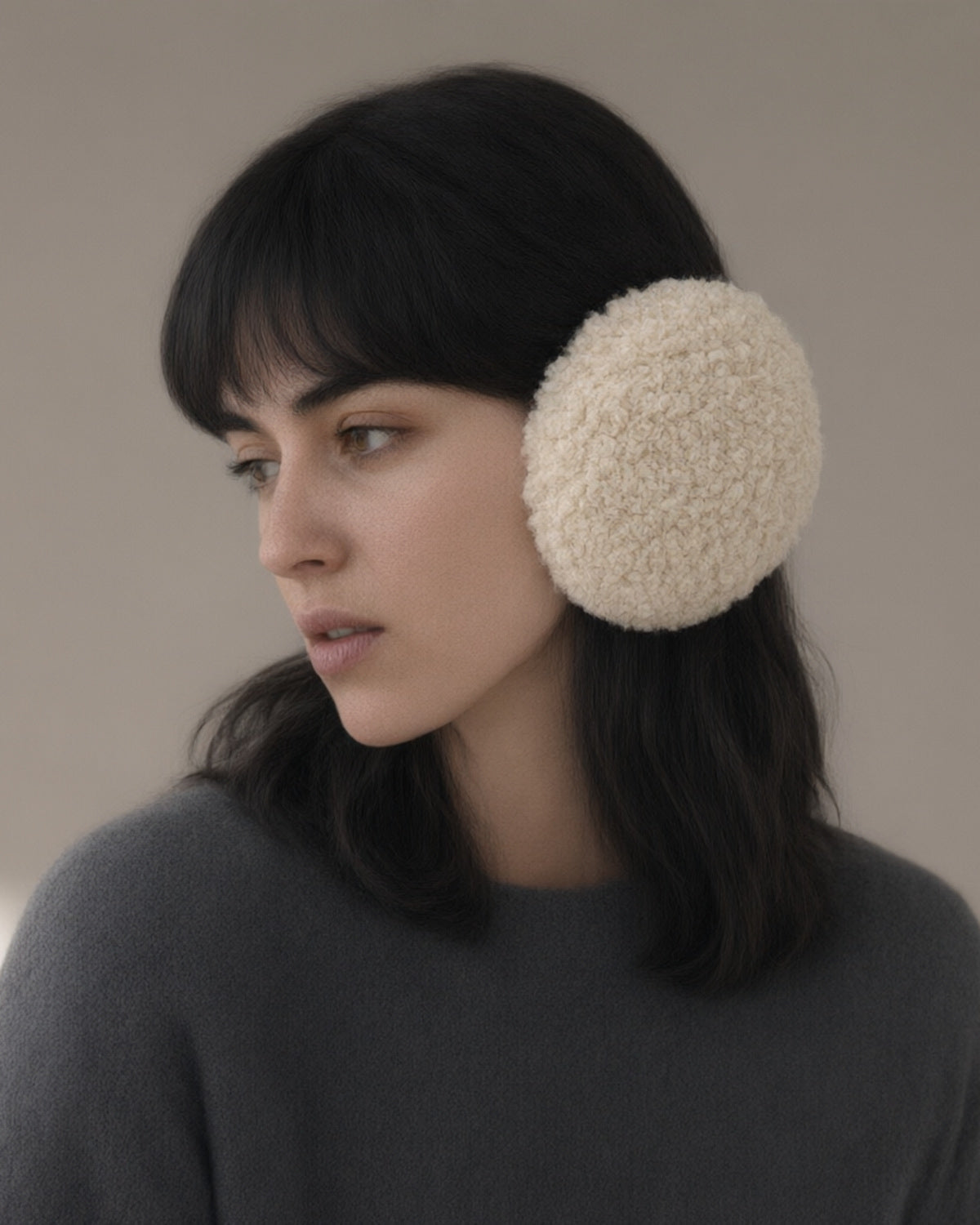Woman wearing the windproof fleece earmuffs, folding band, three-quarter view, studio