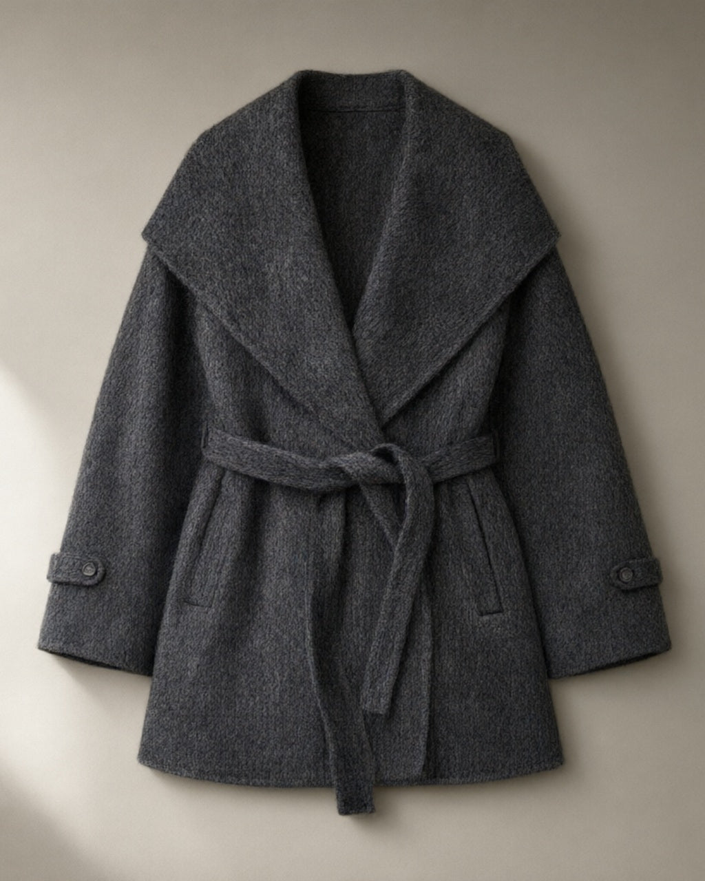 Women’s Belted Wrap Coat, Oversized Fold Collar, laid flat on a stone backdrop