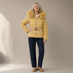 Woman wearing the faux fur trim hooded puffer jacket, belted, full length, studio