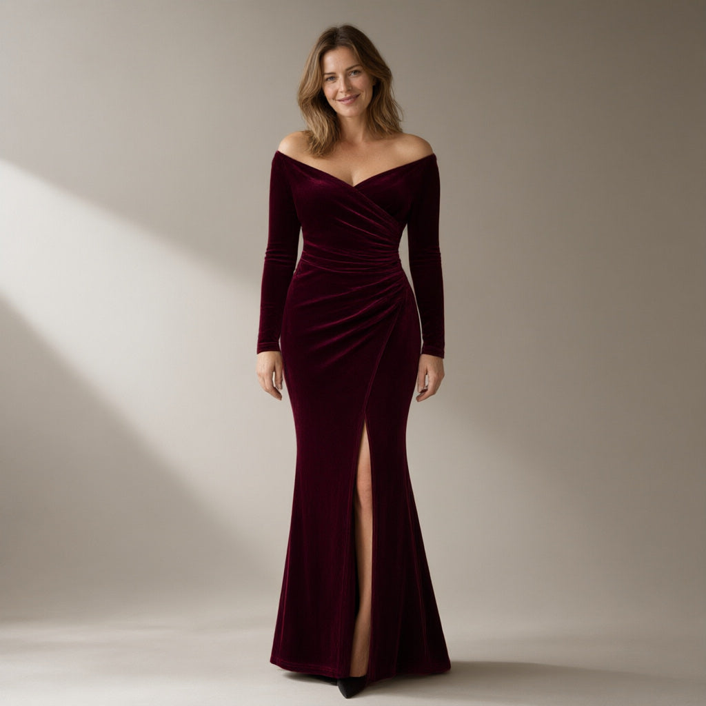 Woman wearing a wine velvet off-shoulder mermaid gown, full length, front view