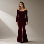 Woman wearing a wine velvet off-shoulder mermaid gown, full length, front view