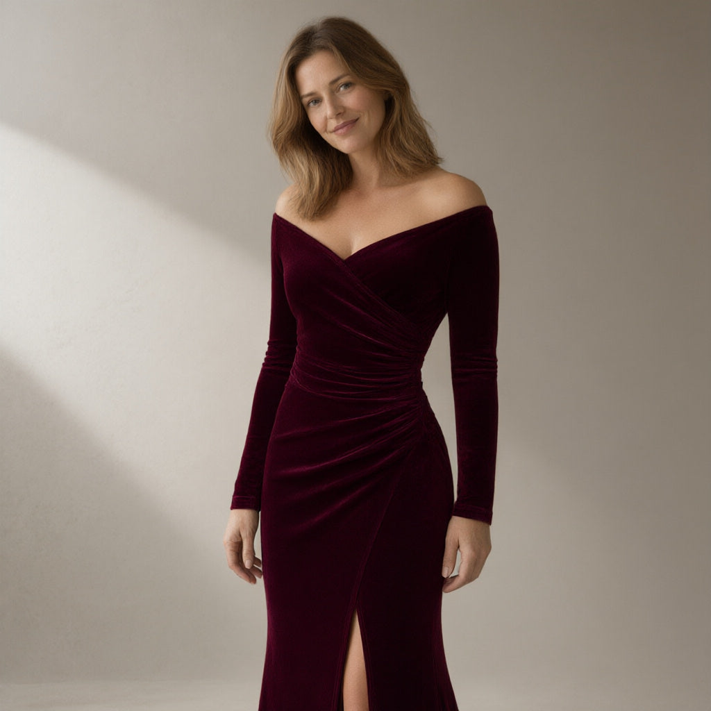 Woman wearing a wine velvet off-shoulder mermaid gown, three-quarter turn