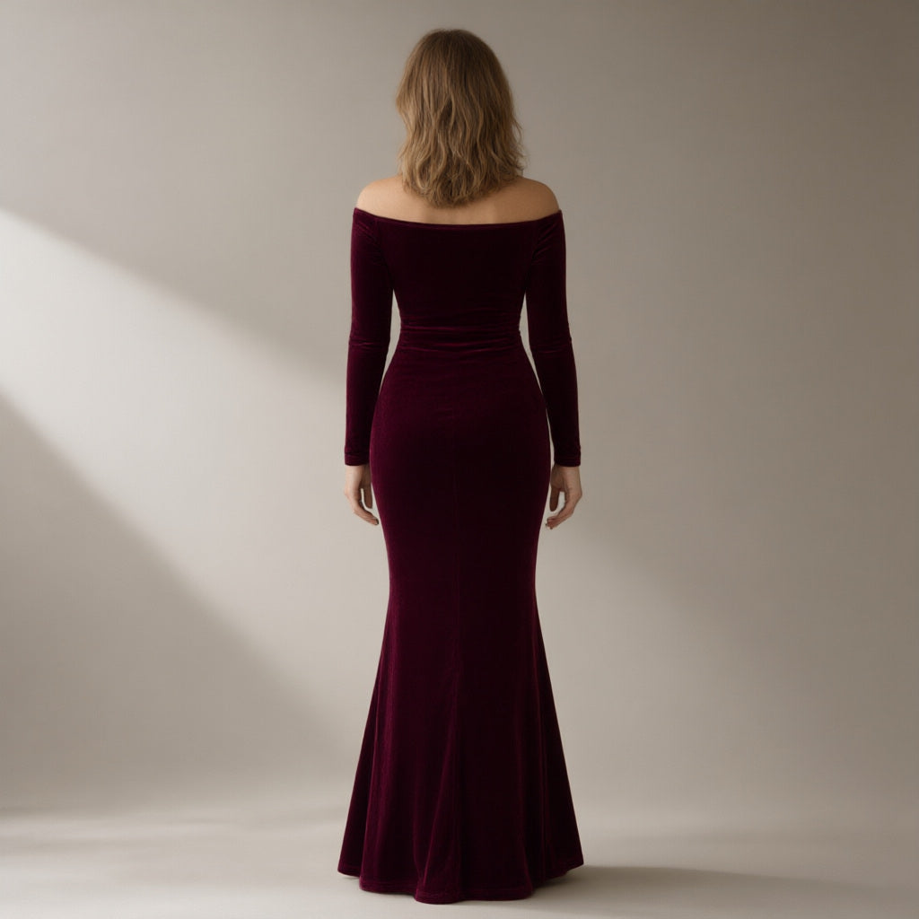 Woman seen from behind wearing a wine velvet off-shoulder mermaid gown, back view
