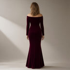 Woman seen from behind wearing a wine velvet off-shoulder mermaid gown, back view