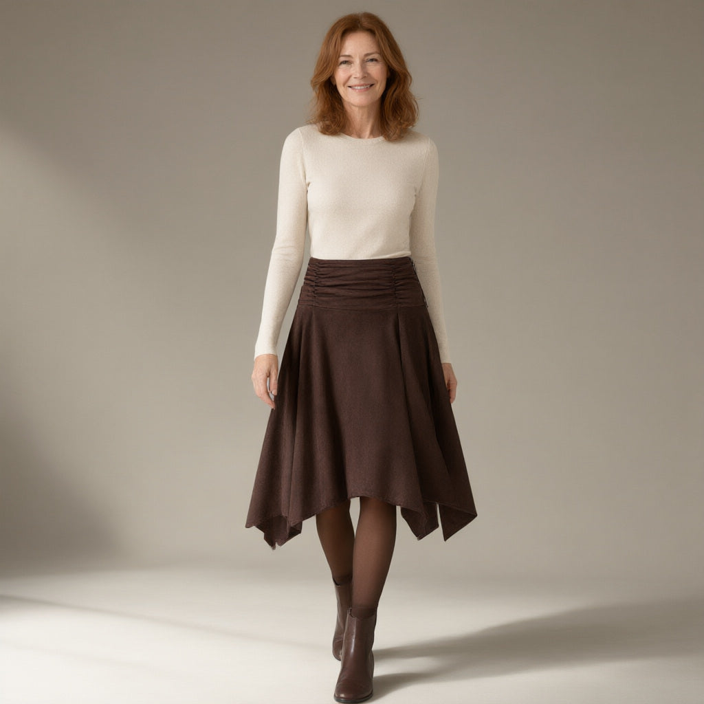 Woman wearing the handkerchief hem suede-look midi skirt, ruched waist, full length, studio