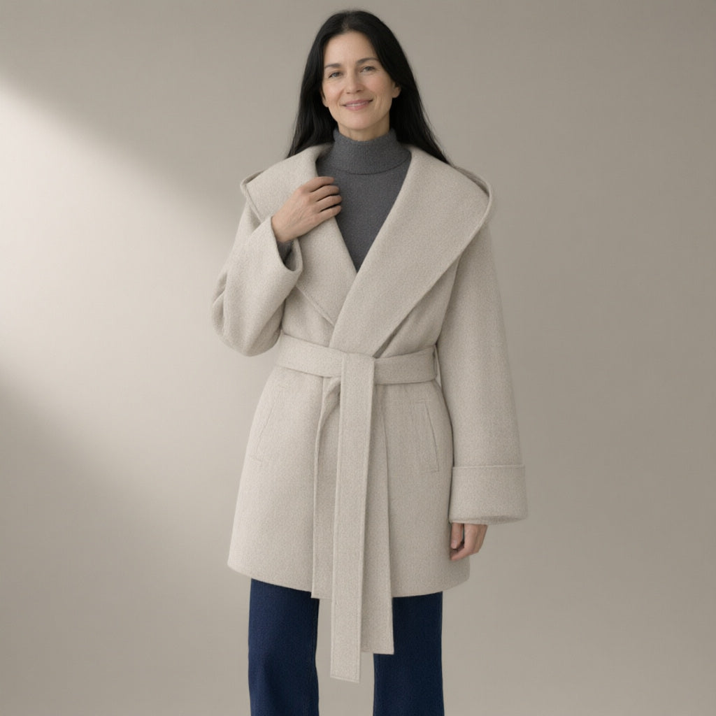 Woman wearing the hooded belted wool coat, double-faced – off-white, three-quarter view, studio