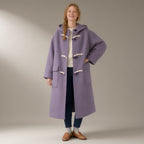 Woman wearing the hooded duffle coat, toggle fasten, double-faced wool blend, full length, studio