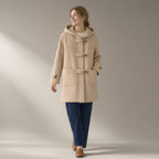 Woman wearing the horn-button hooded duffle coat, wool-look, full length, studio