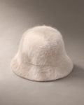 Women’s Knit Fluffy Bucket Hat, laid flat on a stone backdrop