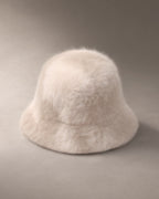 Women’s Knit Fluffy Bucket Hat, laid flat on a stone backdrop