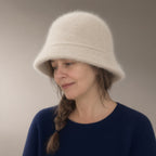 Woman wearing the knit fluffy bucket hat, three-quarter view, studio