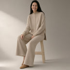 Woman wearing the knit jumper & wide-leg trouser set – oatmeal, full length, studio