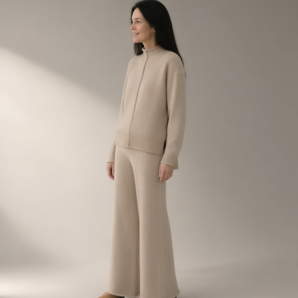 Woman wearing the knit jumper & wide-leg trouser set – oatmeal, three-quarter view, studio