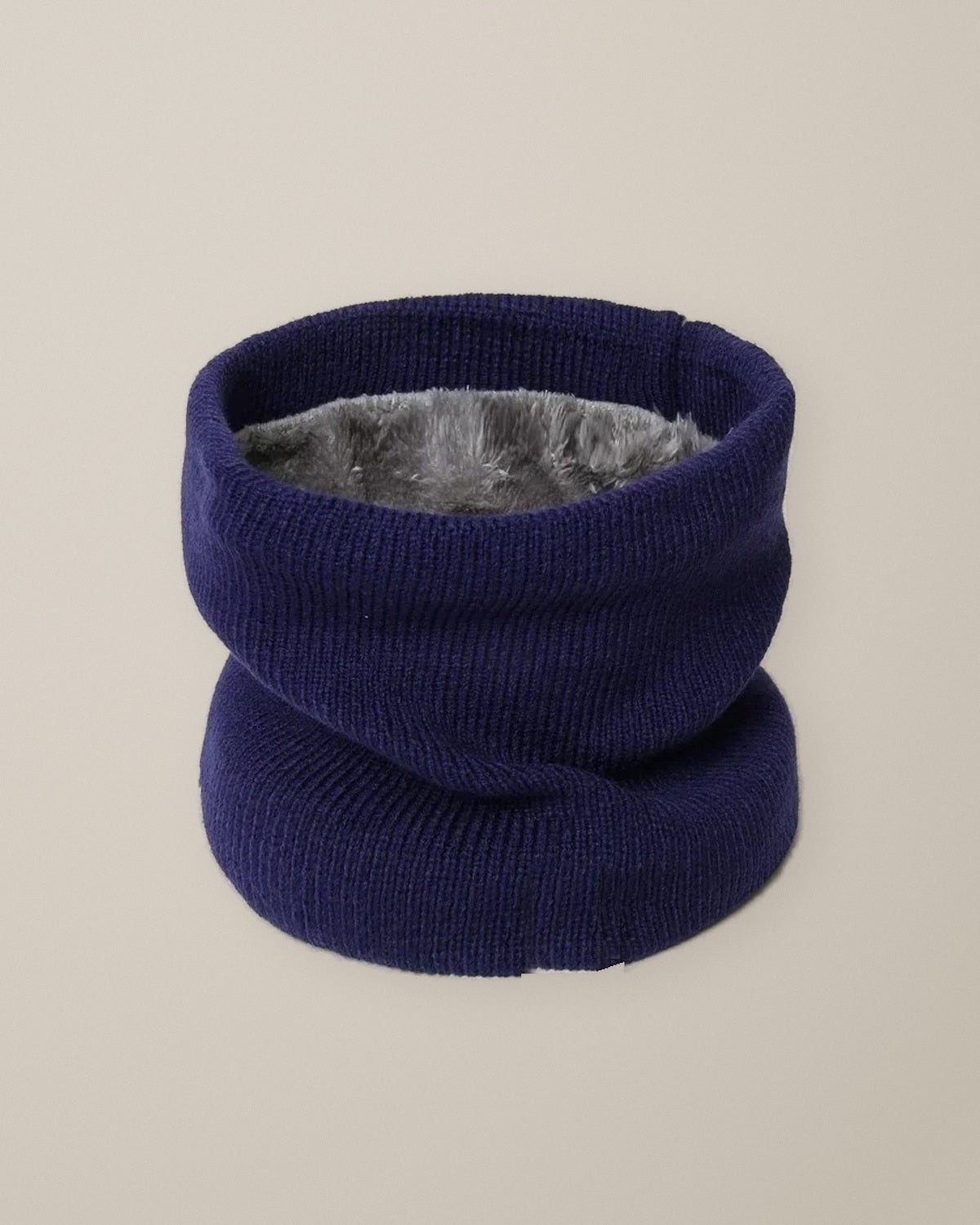 Women’s Knitted Fleece-Lined Snood, Pull-On Neck Warmer, laid flat on a stone backdrop