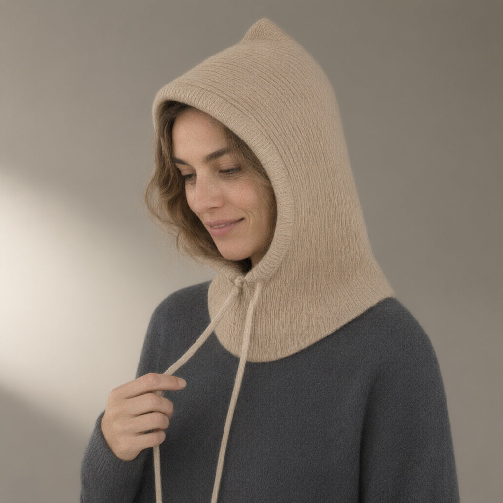 Woman wearing the knitted hood, drawstring neck, three-quarter view, studio