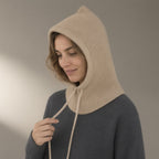 Woman wearing the knitted hood, drawstring neck, three-quarter view, studio