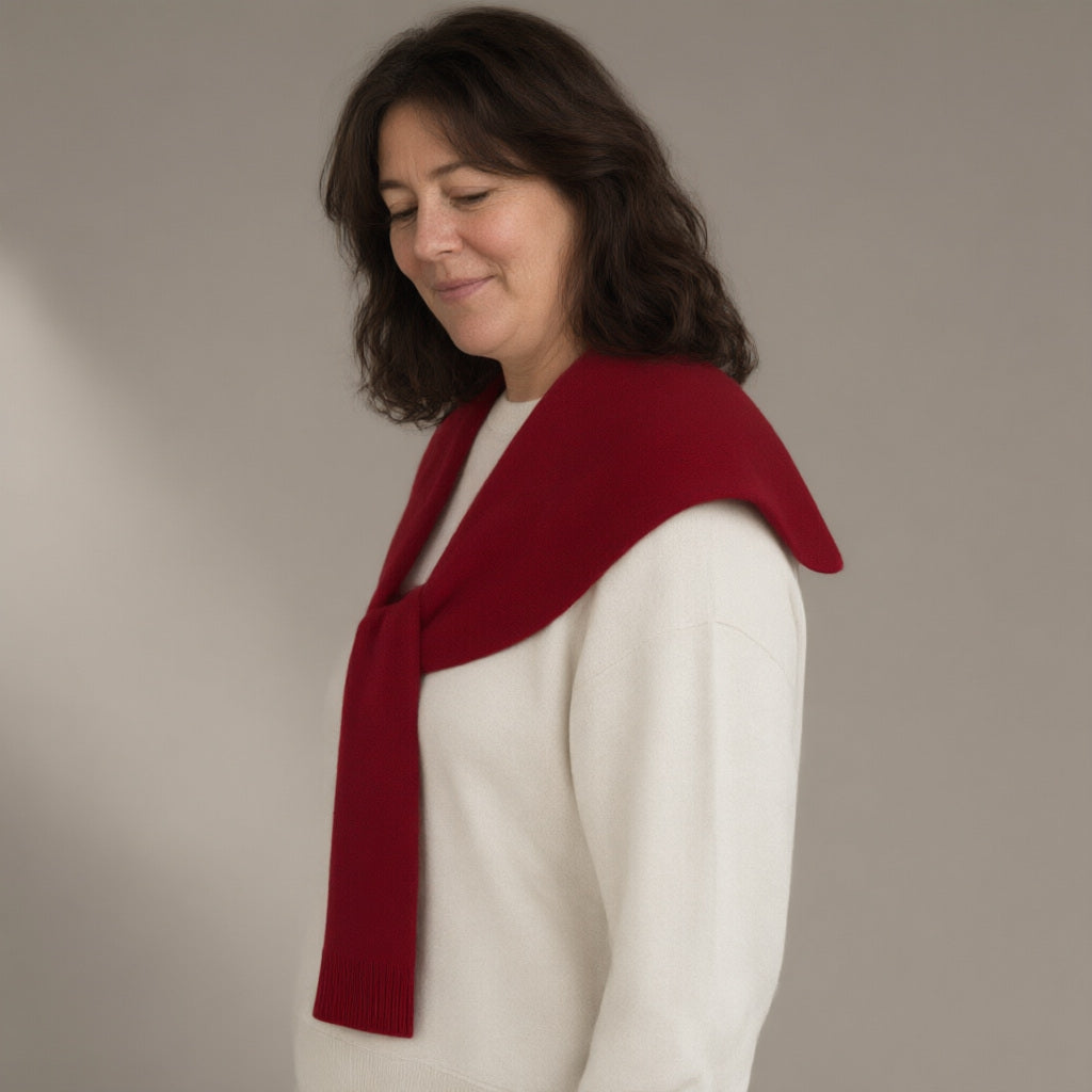 Woman wearing the knitted pull-through collar wrap, three-quarter view, studio
