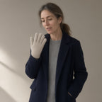 Woman wearing the knitted stretch gloves, wrist-length, three-quarter view, studio