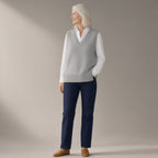 Woman wearing the knitted v-neck sweater vest, three-quarter view, studio