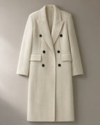 Women’s Long Double-Breasted Wool Coat, Wide Lapel, laid flat on a stone backdrop